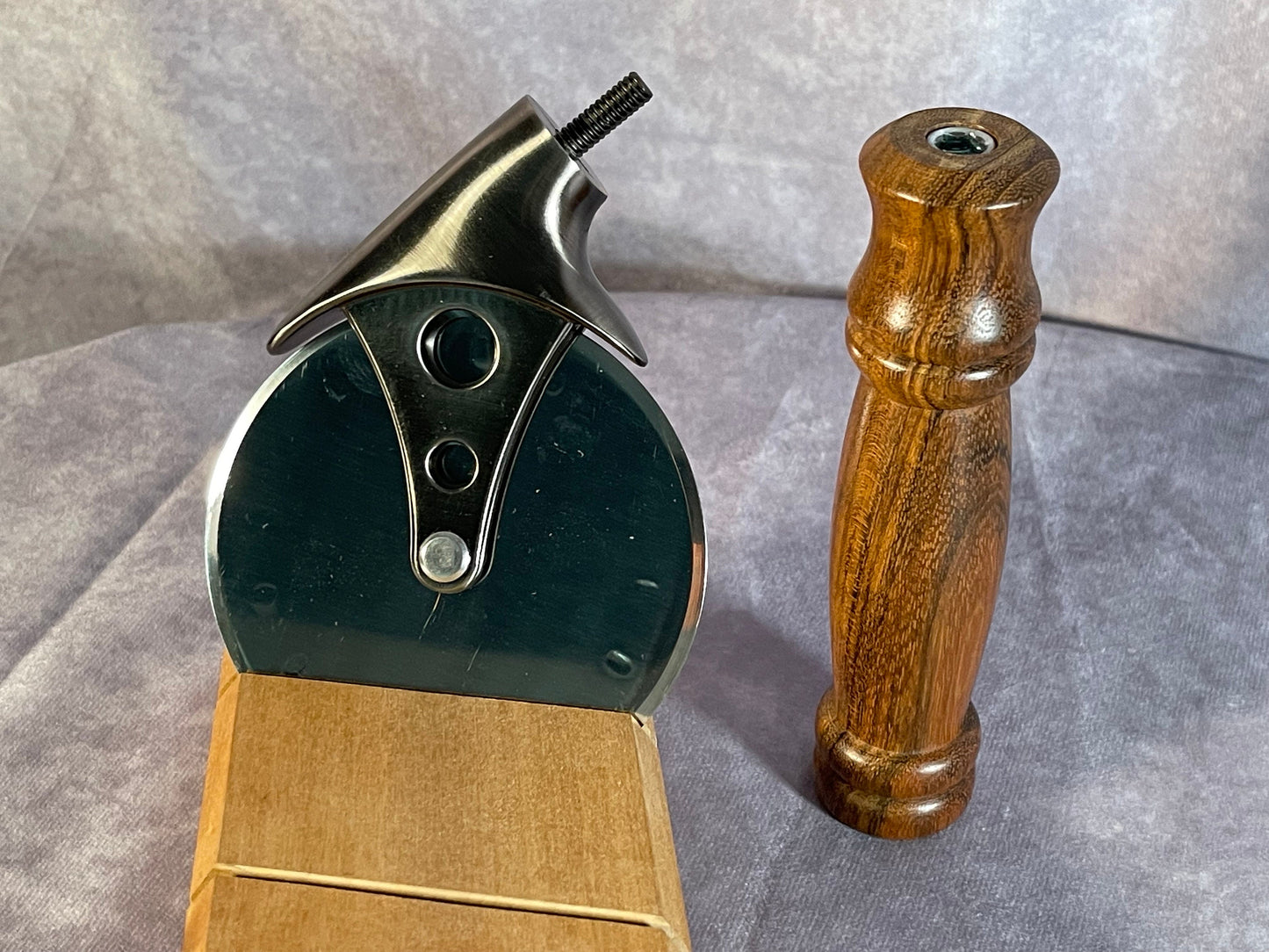 Pizza cutter with handle turned from Monkeypod wood.