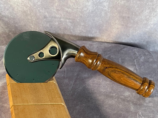 Pizza cutter with handle turned from Monkeypod wood.